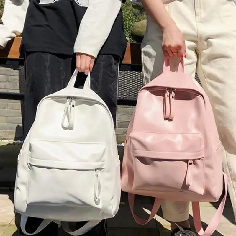 Modern minimalist leather backpack in solid color with exterior zipper pockets