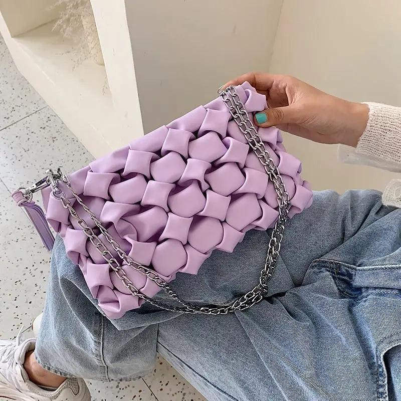 Modern leather crossbody bag featuring a luxury metal chain strap