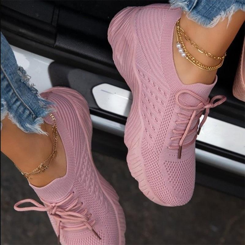 Close-up of women's pink breathable mesh platform sneakers with lace-up design