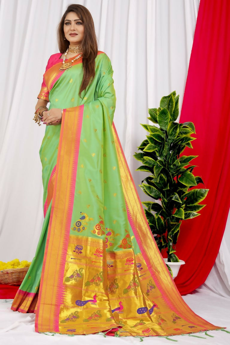Elegant green Paithani silk saree with intricate Zari woven patterns and a pink blouse.