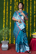 Teal soft handloom silk saree with intricate zari woven work and matching blouse.