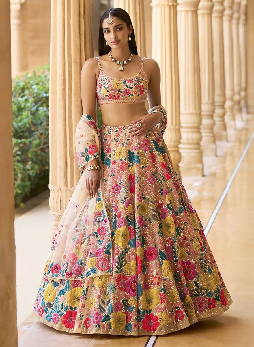 A woman wearing a multicolor faux georgette lehenga choli with heavy 5mm sequins and embroidery work.
