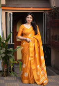 Mustard cotton crepe saree with batik print and zari pattu woven border