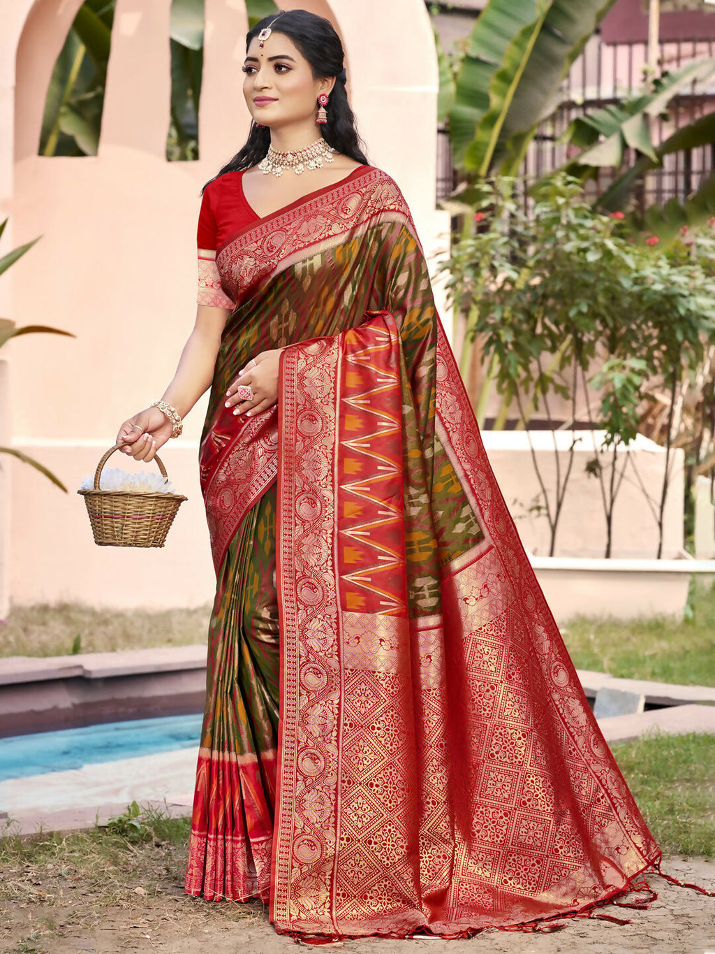 Elegant Mehndi green Pochampally silk saree with matching blouse piece draped elegantly.