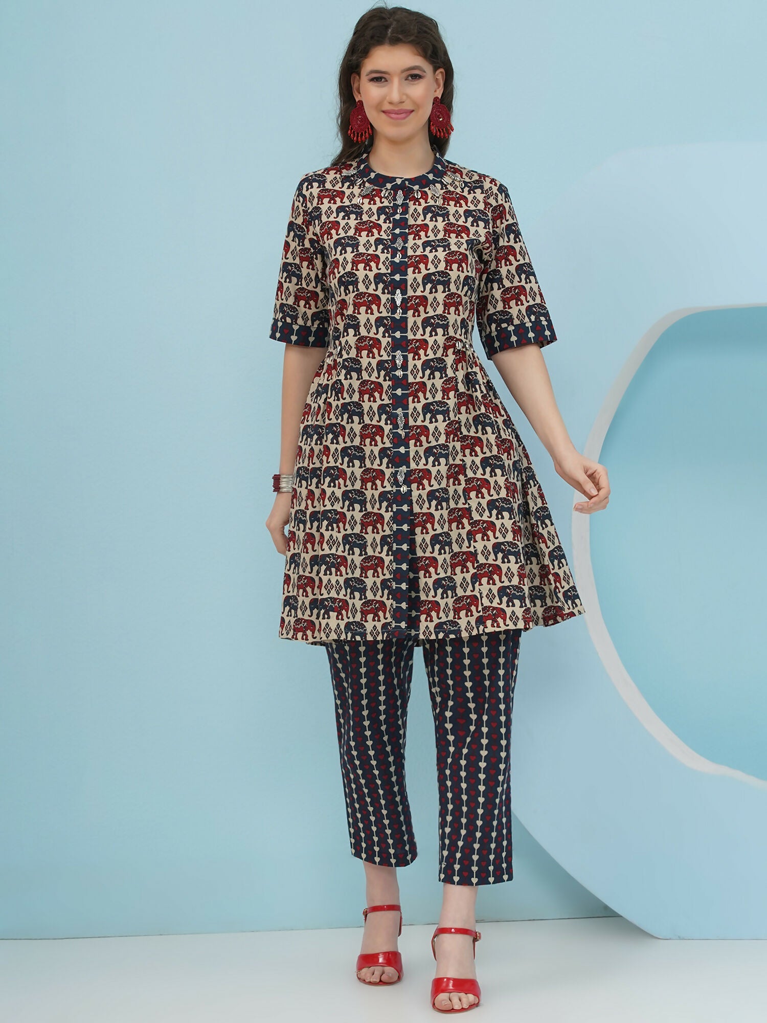 Woman wearing a beige co-ord set featuring a playful elephant print in breathable cotton