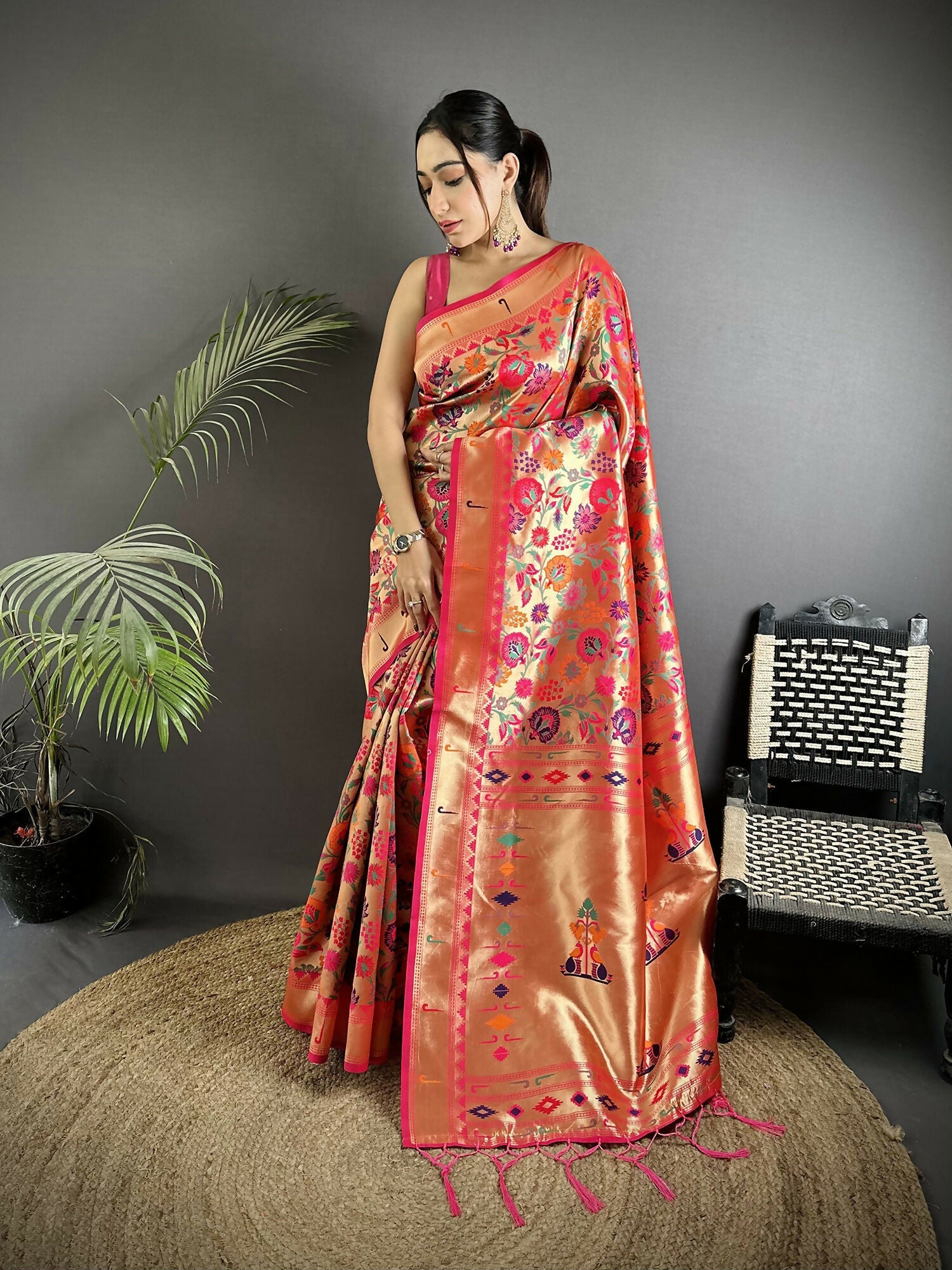 Rani pink soft silk Paithani saree with elaborate zari weaving and traditional motifs.