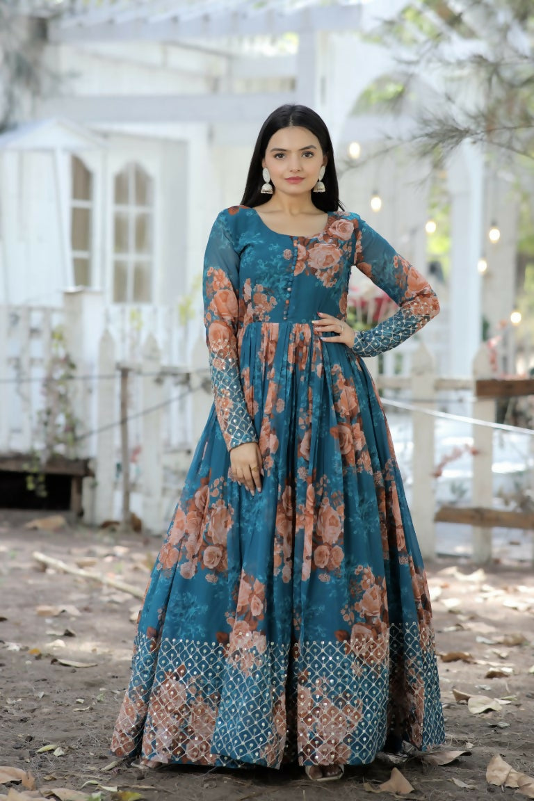 Woman wearing a teal faux georgette Anarkali dress with sequence zari embroidery