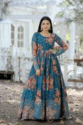 Woman wearing a teal faux georgette Anarkali dress with sequence zari embroidery