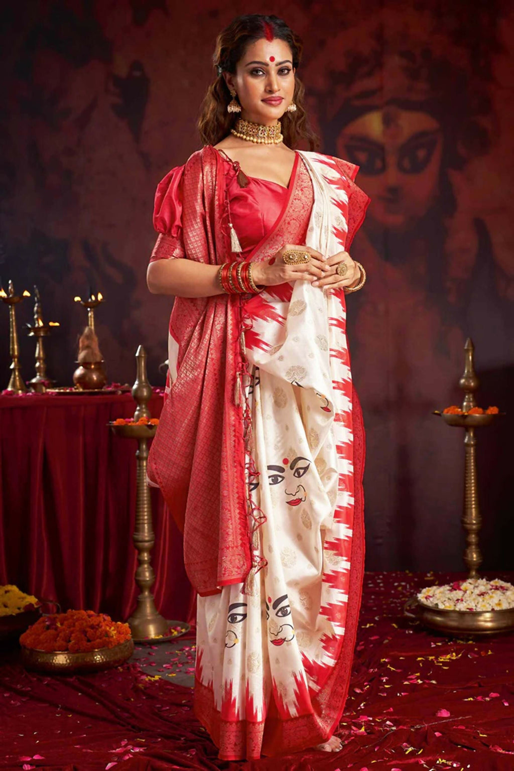 Off-white silk blend Garad saree with traditional ethnic motifs and a contrasting red blouse
