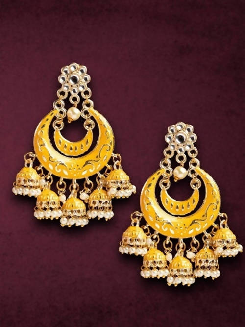 Young girl wearing traditional silver Meenakari Kundan Jhumka earrings for festive occasions