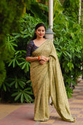 Olive green jute silk saree with jacquard weave and a traditional Kalamkari blouse.
