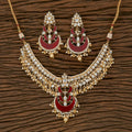 Exquisite golden necklace set with white pearls and maroon onyx stones for traditional ethnic wear.