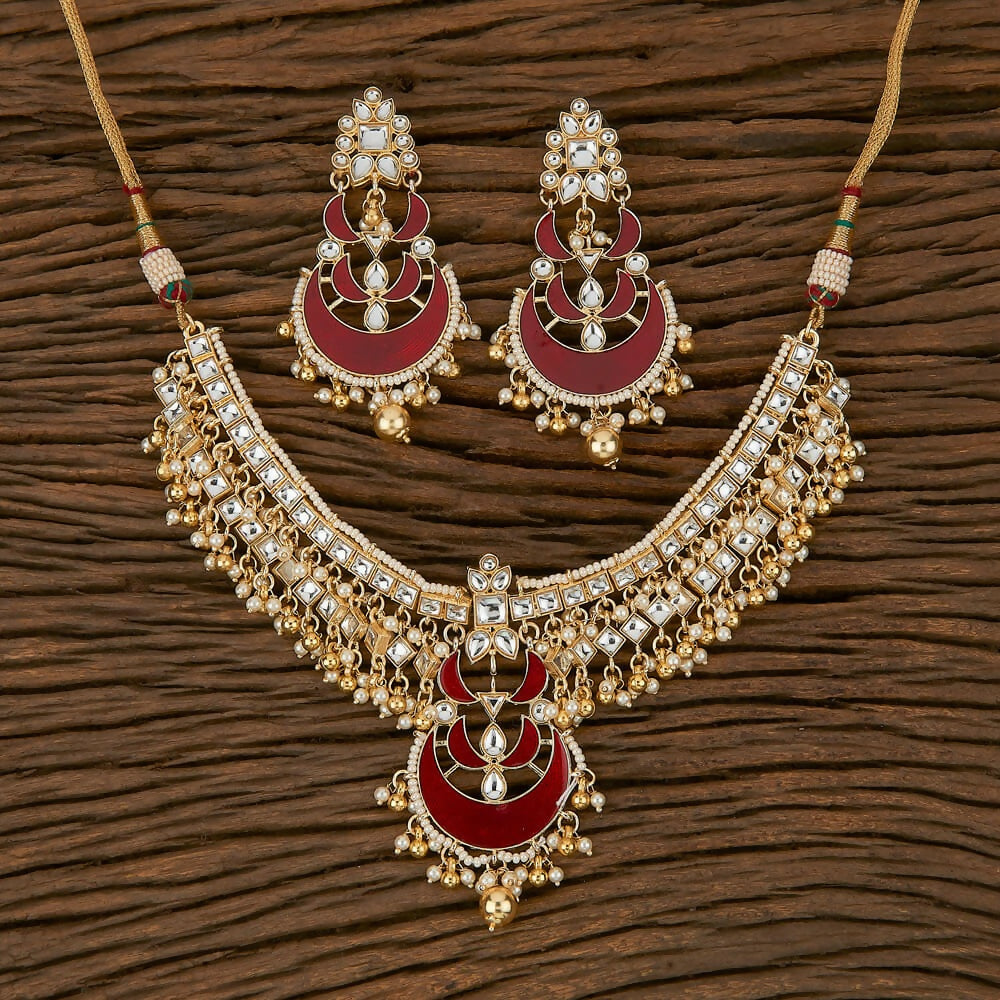 Exquisite golden necklace set with white pearls and maroon onyx stones for traditional ethnic wear.