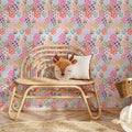 Maelia geometric wallpaper in a bright palette of pink, yellow, light-blue, and peach