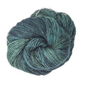 Skein of hand-dyed variegated multi-color Malabrigo Mechita superwash merino yarn for bohemian knit projects.
