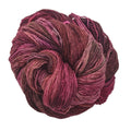 Skein of Malabrigo Rastita Merino Wool yarn in earth tone colors including rust, brown, and olive.