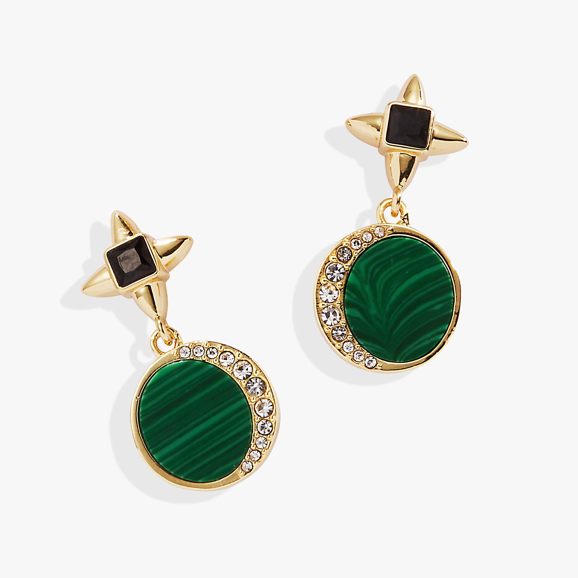 Close up of gold-plated malachite drop earrings with clear crystal moon accents worn by a woman