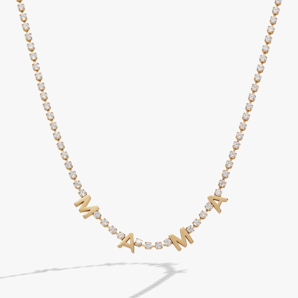 Close up of the Mama Crystal Tennis Necklace on a white background, highlighting crystal chain and MAMA lettering.
