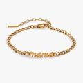 Gold-tone curb chain bracelet with 'Mama' in script font embellished with clear crystals.