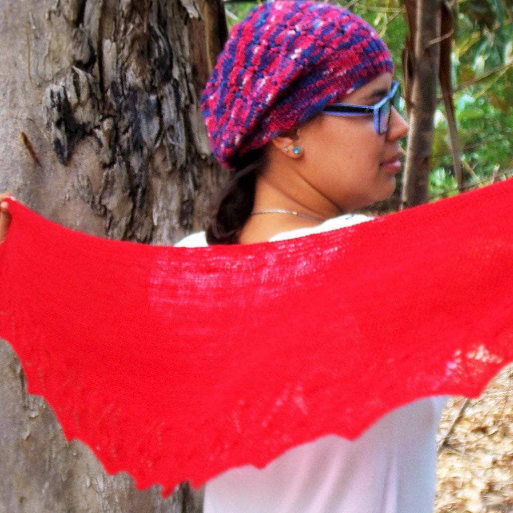Elegant red knit shawl styled for a spring or summer outing