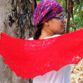 Elegant red knit shawl styled for a spring or summer outing