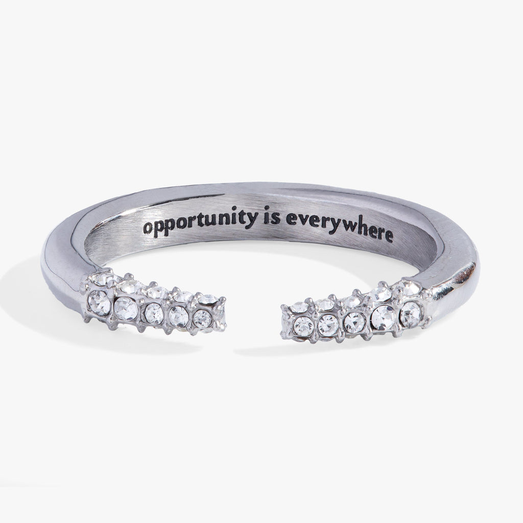 Silver-tone stainless steel open ring with tusk-shaped ends and crystal accents