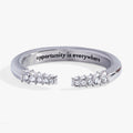 Silver-tone stainless steel open ring with tusk-shaped ends and crystal accents