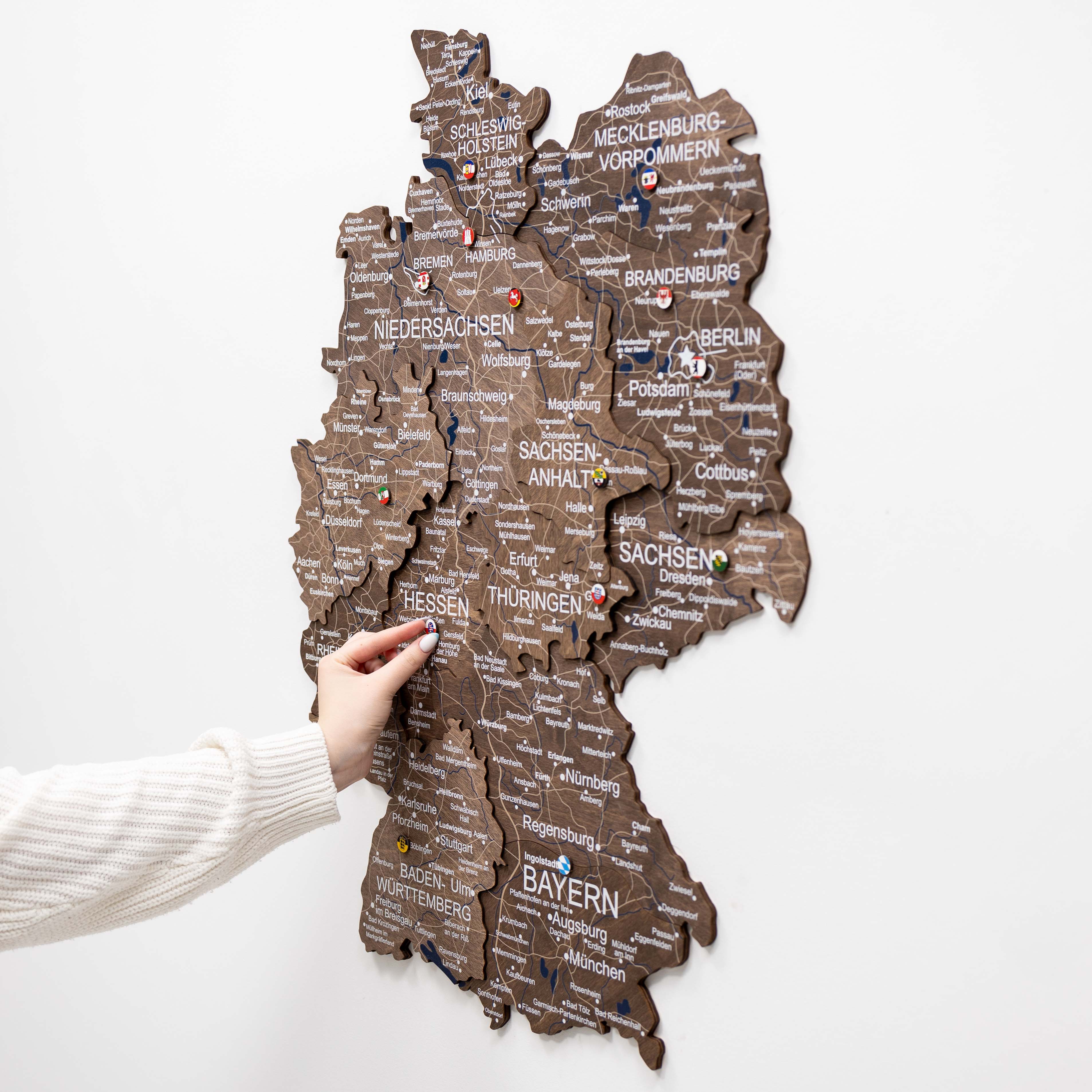 3D Germany wooden map in Dark Walnut finish mounted on a neutral wall
