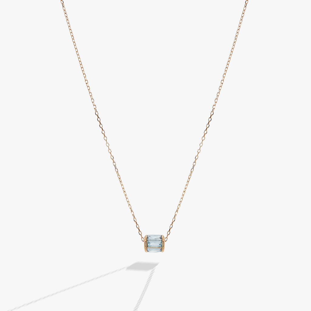 March birthstone barrel charm necklace in light blue with baguette-cut crystals on a metallic chain