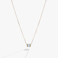 March birthstone barrel charm necklace in light blue with baguette-cut crystals on a metallic chain