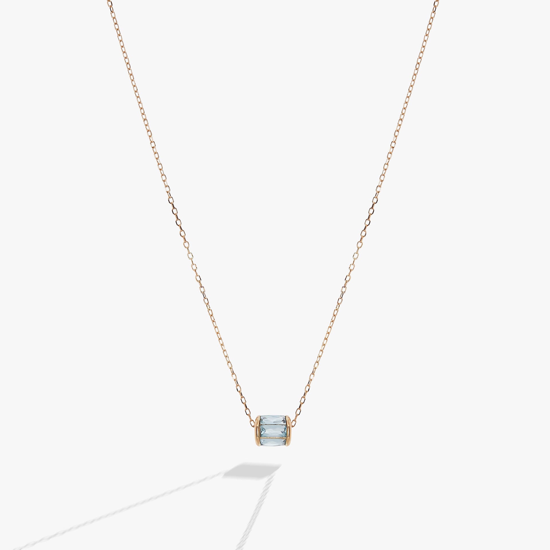 March birthstone barrel charm necklace in light blue with baguette-cut crystals on a metallic chain