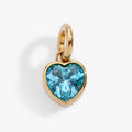 March birthstone heart charm in polished gold tone with a faceted aquamarine blue crystal
