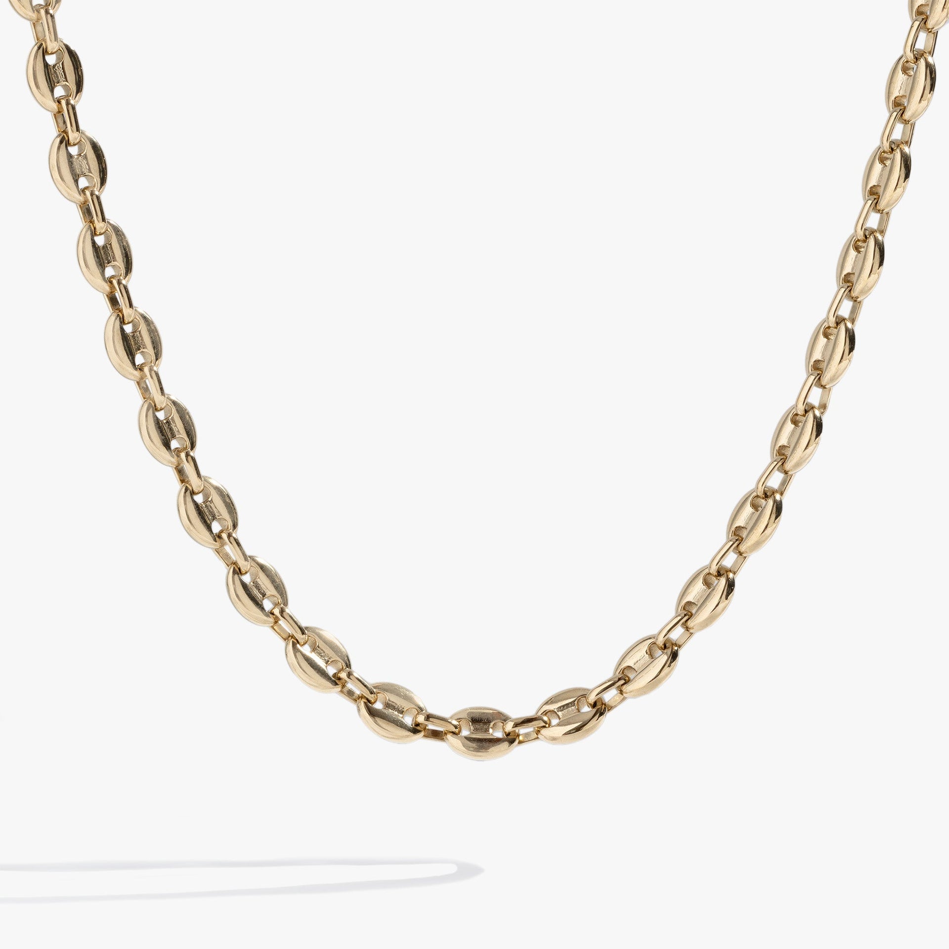 A close-up view of a stainless steel mariner chain necklace featuring polished, interlocking nautical-inspired links.