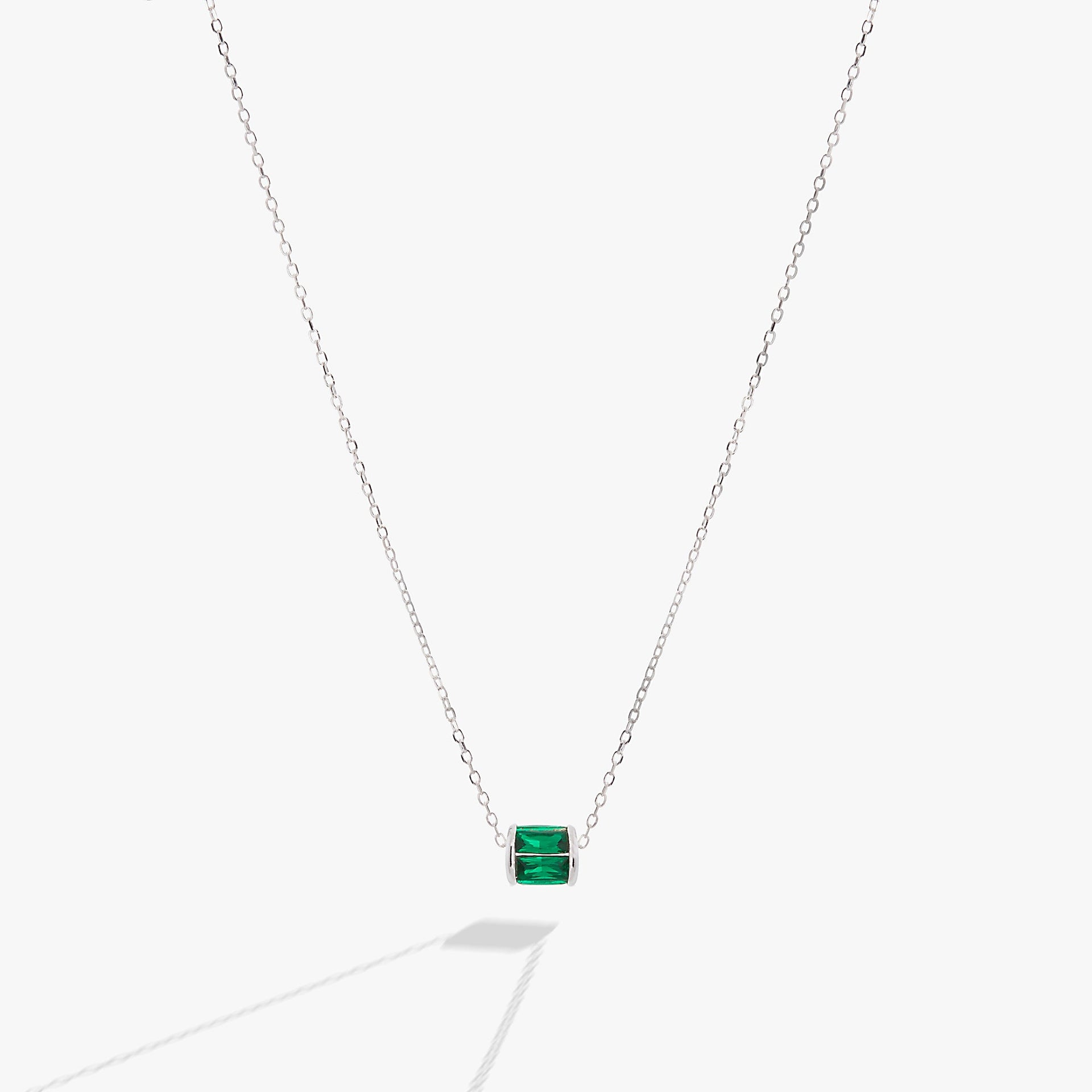 May birthstone pendant necklace featuring emerald-toned baguette crystals on a delicate chain