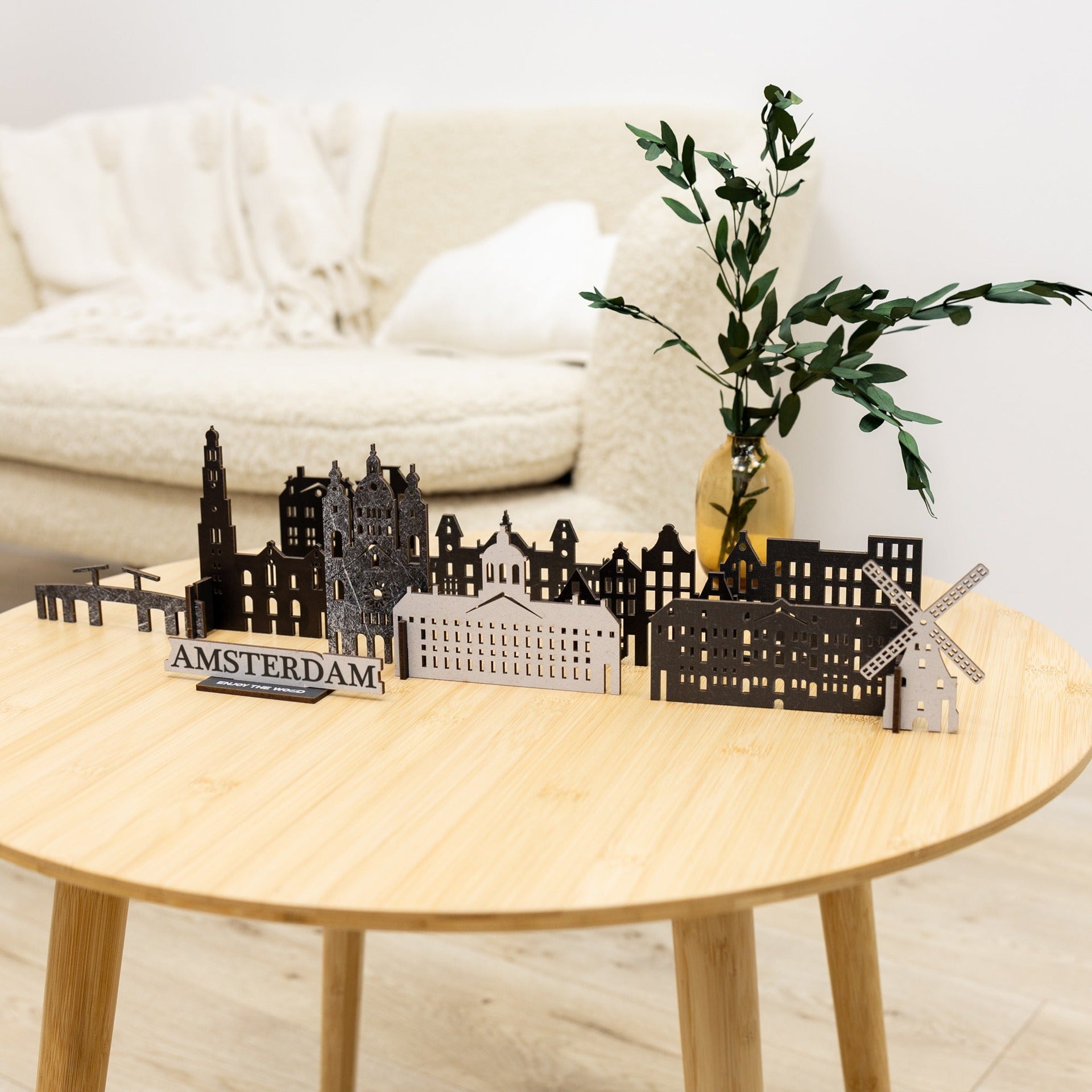 Minimalist 3D wooden Amsterdam skyline sculpture on a clean modern surface