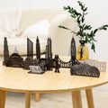 Laser-cut wooden art piece featuring iconic USA building silhouettes
