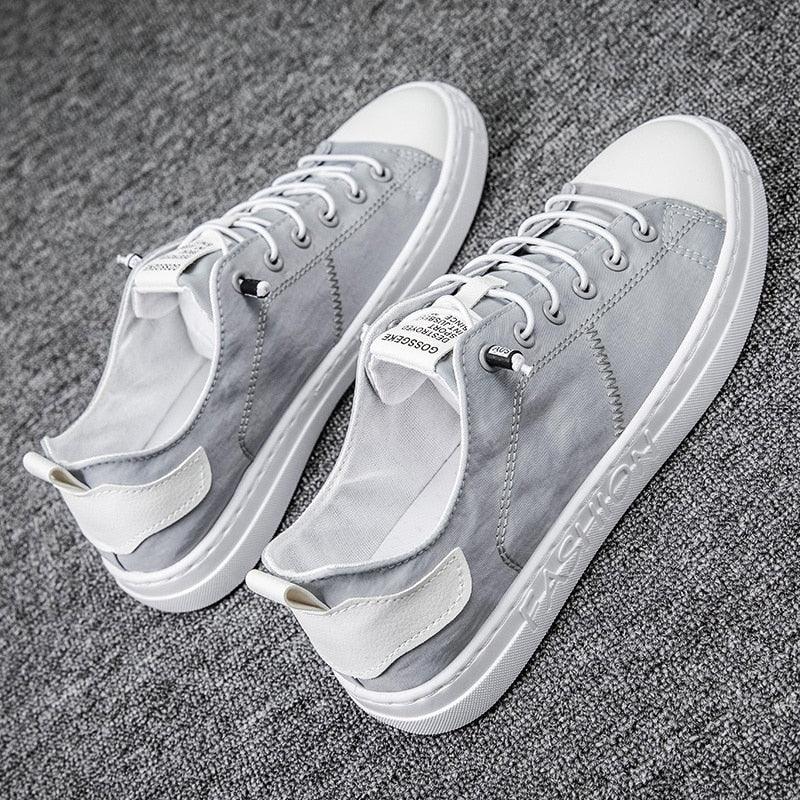 A pair of classic low-top canvas sneakers with lace-up closure in a breathable fabric.