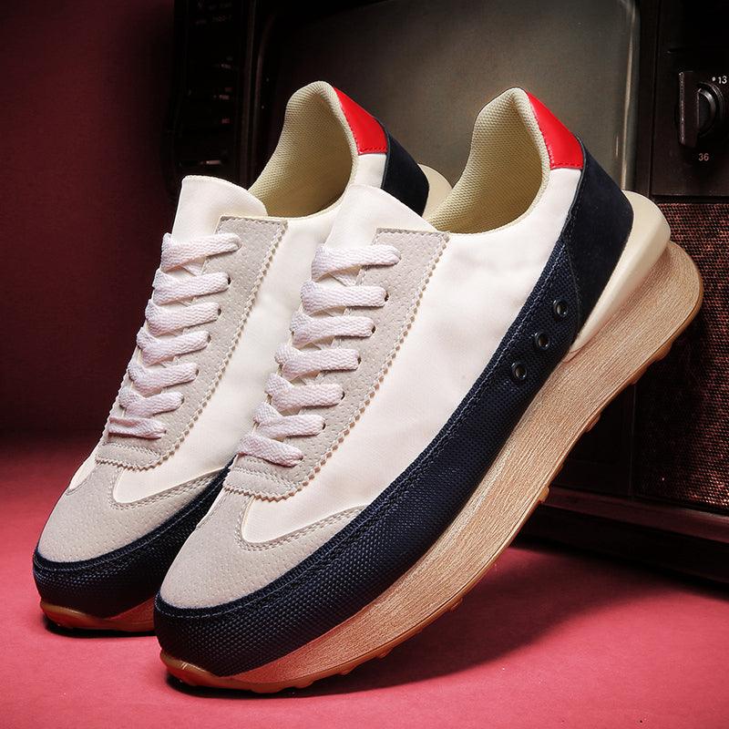 Men's casual platform sneakers in white and navy with faux wood-grain sole and red accents.