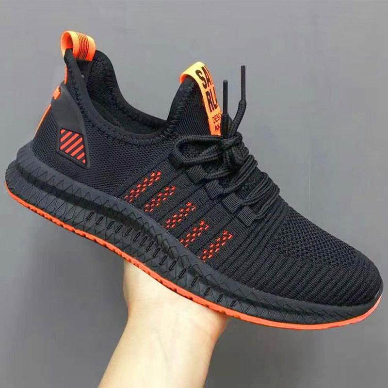 Men's athletic knit trainers with stylish orange sole