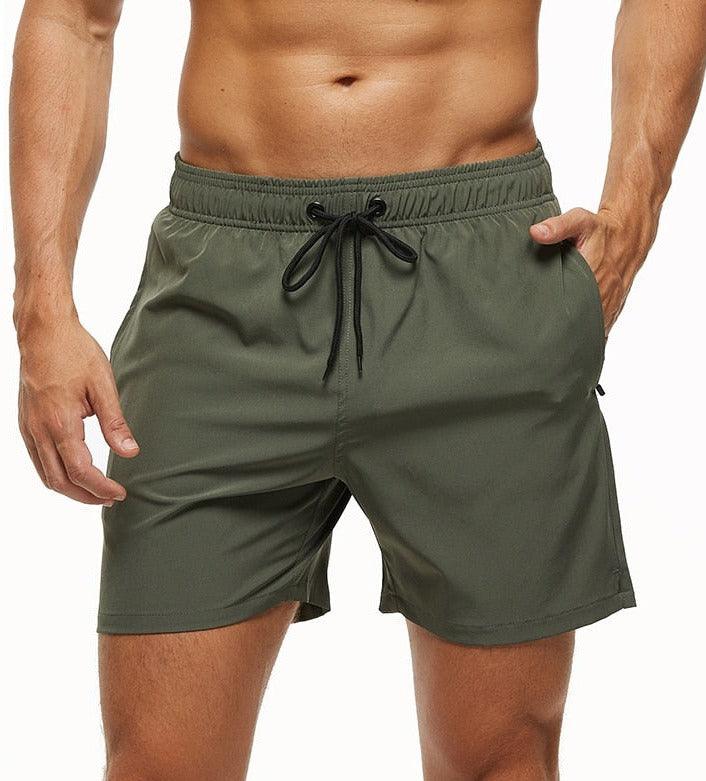Men's solid color quick-dry swim trunks in olive green with drawstring waist and zipper pockets