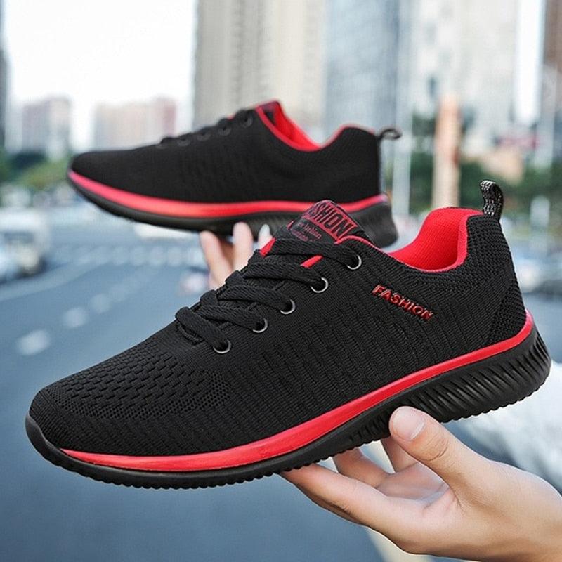 Men's black lightweight knit running sneakers with neon accent details and lace-up closure