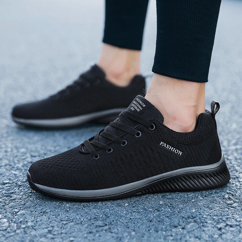 Men's black air mesh running sneakers with platform sole and lace-up closure.