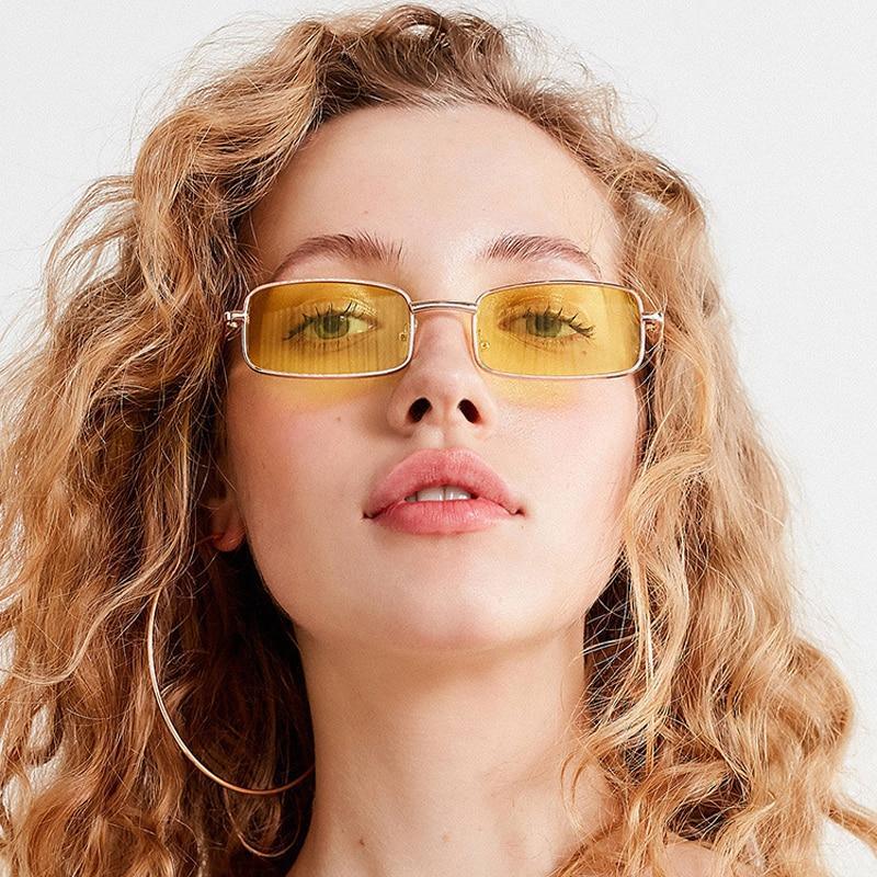 Vintage gold rimless rectangle sunglasses with flame-shaped metal frame on a white background