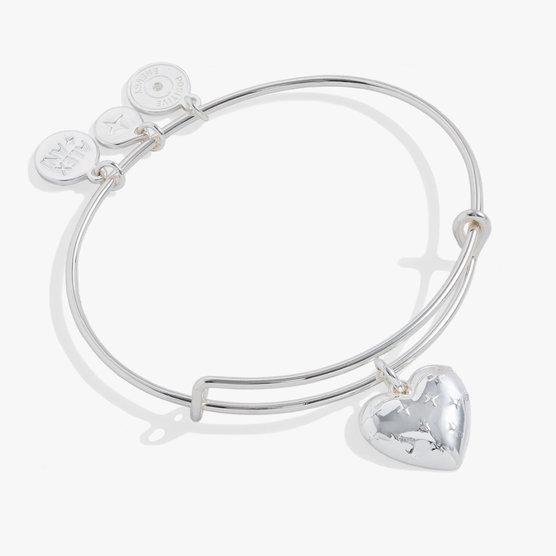 Silver tone expandable bangle featuring a heart charm with starburst engraving on a white background.