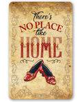 Wizard of Oz There is No Place Like Home metal sign featuring red ruby slippers and vintage scrollwork borders.
