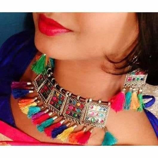 Traditional bohemian choker necklace in multi-color and oxidized silver finish worn by a woman