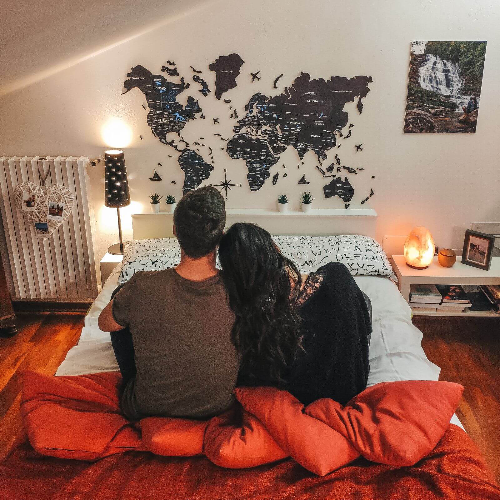 3D Wooden World Map Midnight in charcoal and midnight-blue hues mounted on a modern wall.