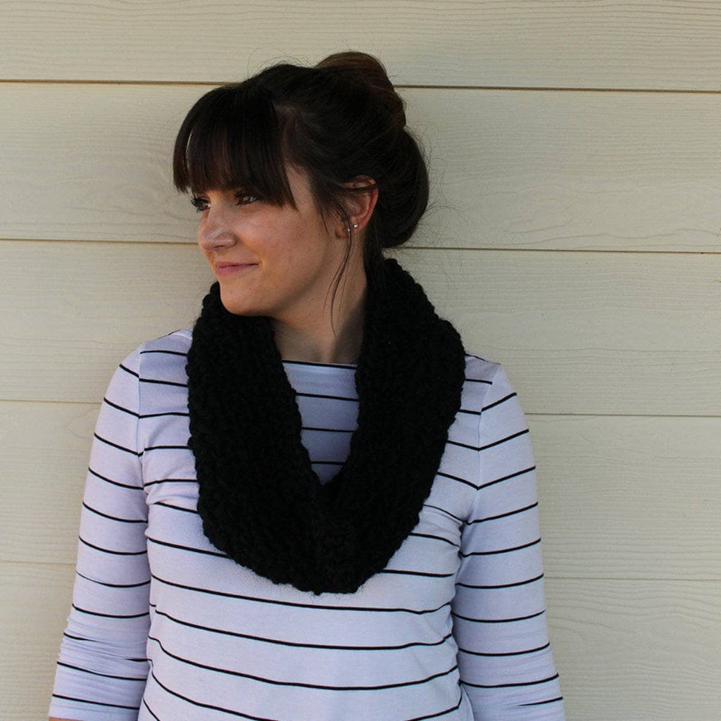 Finished Midnight Scarf made from variegated thick and thin wool yarn, neatly folded.