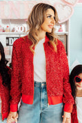 A woman wearing a vibrant red sequin bomber jacket with ribbed cuffs and a front zipper.