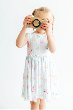 Girl wearing a soft Malibu Girl Tank Twirl Dress with a ballet neckline and full skirt.
